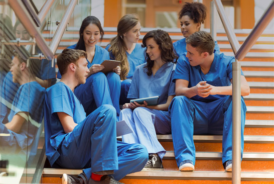 UC San Diego health / medical students in scrubs, sitting on steps